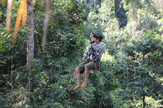 Our guide on the zip-line to the treehouse taking photos of the it.